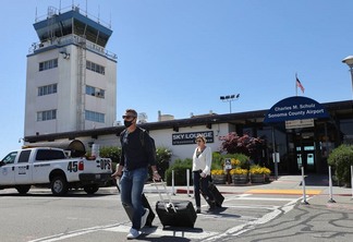 Dan and Emily Imler walk out of the Charles M. Schulz-Sonoma County Airport, after arriving from Orange County, in Santa Rosa on Thursday, April 15, 2021.  (Christopher Chung/ The Press Democrat)